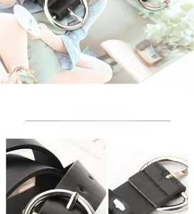 Detail view of a classic black leather belt for women featuring a large silver round buckle