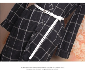 Close-up of white hollow leather belt with silver buckle on black and white checkered dress