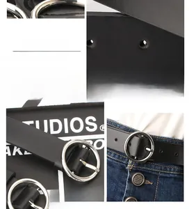 Detail of black PU leather belt with silver round buckle and textured grain finish