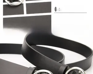 Close-up of black leather belt showing premium stitching and a round silver metal buckle