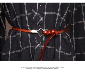 Detail of slim genuine leather belt with a unique silver geometric rhombus buckle