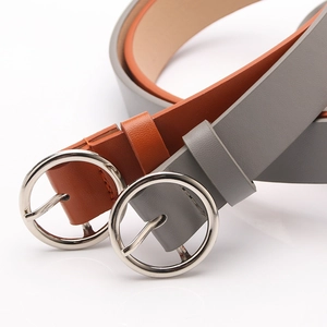 Minimalist women leather belts in brown and grey with silver round buckles on white background