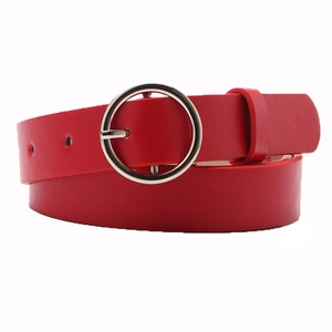 Minimalist red leather belt for women with elegant round silver buckle on white background