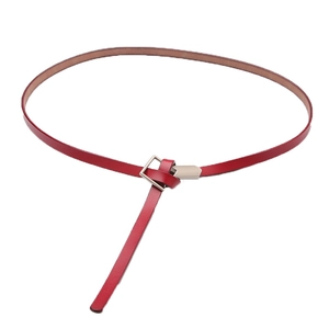 Minimalist red leather waist belt for women with silver buckle and knotted styling