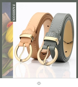 Detail of thin faux leather belts with lychee texture and round vintage gold buckles