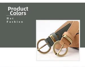 Close-up of slim synthetic leather belts with vintage round brass buckles in grey and brown