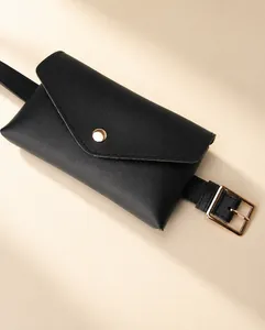 Detail of black leather envelope waist bag with adjustable belt and gold metal buckle