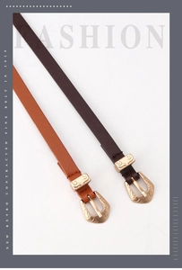 Detailed shot of dark brown and caramel leather belts with vintage gold floral buckles