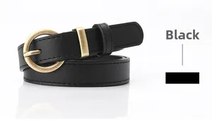 Detailed close-up of a slim black leather belt featuring a vintage gold round metal buckle