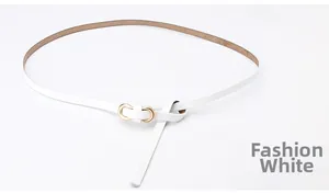 Detailed macro view of white genuine leather belt featuring a golden U-shaped alloy buckle