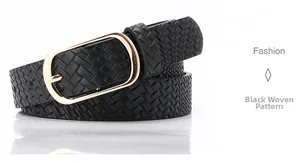 Macro shot of black woven texture leather belt with a golden oval metal pin buckle