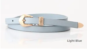Detail of light blue leather belt with intricate gold floral buckle for summer dresses