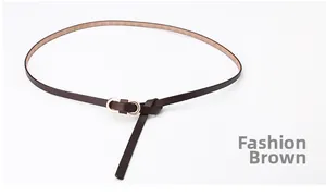 Detail of slim coffee leather belt with gold double oval buckle for stylish women dresses