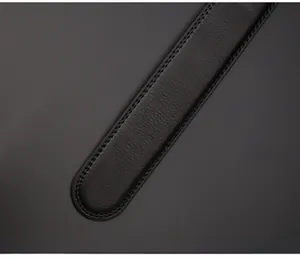 Detail of round belt tip featuring durable double-stitching and premium black leather texture