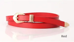 Close-up of red leather belt featuring intricate vintage gold floral engraved buckle