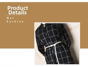 Detail view of a white minimalist slim leather belt styled on a black and white plaid dress