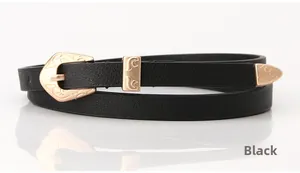 Detail of thin black leather belt featuring vintage floral engraved gold buckle and tip