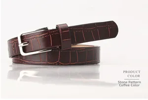 Close-up of vintage brown leather belt with stone texture and silver metal buckle