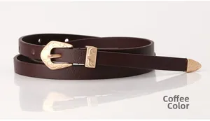 Close-up of coffee brown slim belt featuring vintage gold floral engraved buckle and tip
