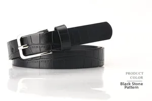Detail of black faux leather belt with crocodile texture and silver metal buckle