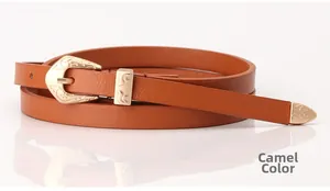 Detail view of camel PU leather belt with engraved gold buckle and metallic tip