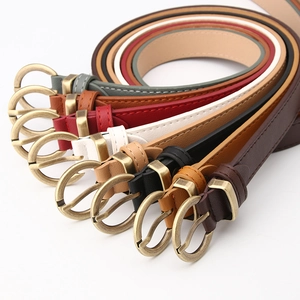 Detail view of 8 slim fashion belts in multiple colors with vintage bronze metal buckles
