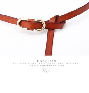 Detail of a knotted brown leather thin belt featuring a gold oval double-ring buckle