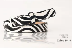 Detailed view of women's zebra print faux leather belt with a silver metal buckle