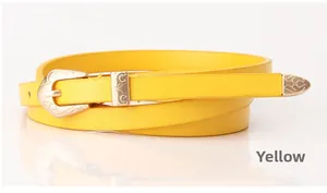 Detailed macro view of yellow matte PU leather belt with vintage floral gold metal buckle