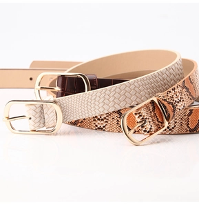 Close-up of three fashion belts with gold pin buckles in snake, woven, and croc textures