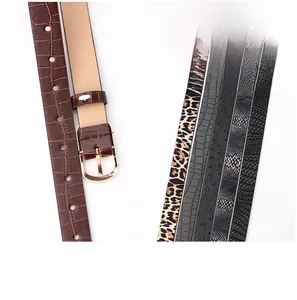 Detail showing five assorted leather belts with animal prints and gold buckles