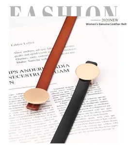 Detail of slim genuine leather belts for women with round gold buckles in black and brown