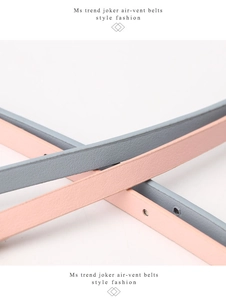 Close-up of pink and grey matte PU leather belts featuring sleek round air-vent eyelets