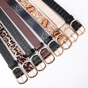 Women's stylish belts with animal prints and gold buckles on a white background