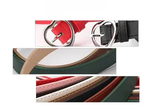 Detail of slim faux leather belt with silver heart-shaped metal pin buckle and stitching