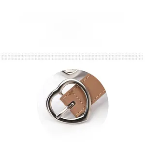 Detail of a brown leather belt featuring a silver heart-shaped metal buckle on white background