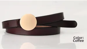 Close-up of slim coffee leather belt with elegant round matte gold metal buckle