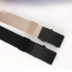 Detailed macro view of khaki and black woven nylon belts with matte metal buckles
