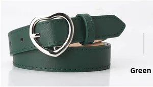 Detailed view of deep green leather belt with silver heart shaped pin buckle closure