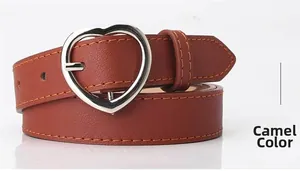 Detailed view of camel faux leather belt with silver heart-shaped buckle and orange stitching
