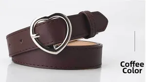 Detail of coffee brown faux leather belt with a polished silver heart-shaped metal buckle