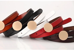 Detailed stack of genuine leather thin belts in five colors with matte gold round buckles