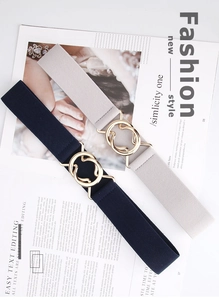 Close-up of dual-ring gold metal buckles on navy and beige elastic woven belts