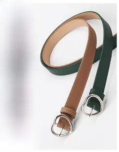 Detail showing heart-shaped metal pin buckle and decorative heart punch on leather belt