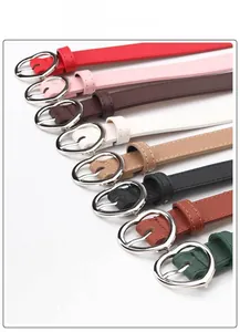 Close-up showing various colors of slim belts with silver heart-shaped alloy buckles