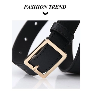 Detail of a black leather belt featuring a golden square buckle and fine stitching
