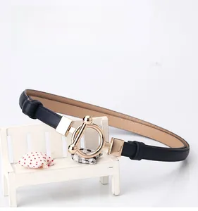 Detail of dark blue leather slim belt with gold round T-buckle for dresses