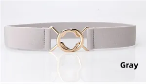 Detail of grey elastic waist belt with a decorative gold double-ring metal buckle