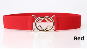 Detail of red wide elastic waist belt for women with gold double ring interlocking buckle