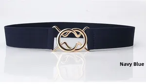 Detailed close-up of navy blue elastic waist belt with gold interlocking double ring buckle